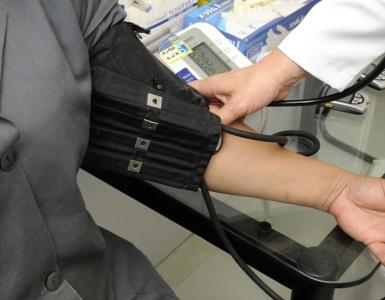 Doctor taking patient's blood pressure